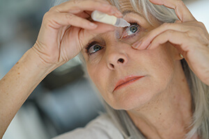 Woman using eye drops for Glaucoma treatment